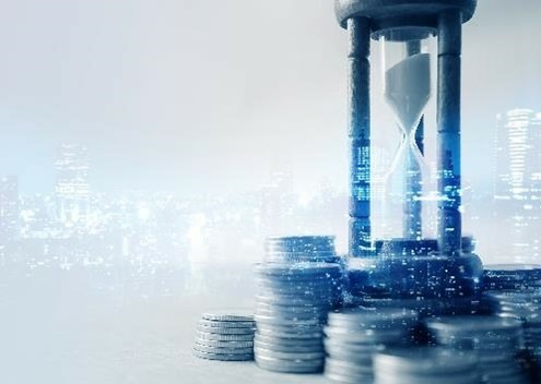 Münzgeld und Sanduhr für etwa die Zeit des Finanzkonzepts